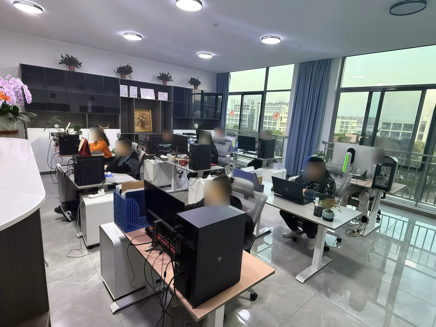 日常办公现场，人员面部已作隐私模糊处理